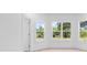 Bright room with large windows offering picturesque views of lush greenery and serene pond at 722 Highway 348, Loris, SC 29569