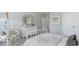 Serene bedroom with a white bed, woven chair, dresser and a view of the bedroom's closet at 723 Rupert Dr, Conway, SC 29526