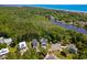 Scenic aerial view highlighting homes close to a river, lush forests, and the ocean at 77 Streater Ln., Pawleys Island, SC 29585