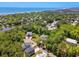 Aerial view showcasing homes in a lush, green community near a lake and the ocean at 77 Streater Ln., Pawleys Island, SC 29585