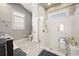 Modern bathroom features a walk-in shower with glass enclosure and ample natural light from the window at 77 Streater Ln., Pawleys Island, SC 29585