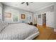 Spacious bedroom showcasing a large bed, sitting area, and access to a walk-in closet and bathroom at 77 Streater Ln., Pawleys Island, SC 29585