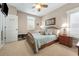 Cozy bedroom with neutral walls, ceiling fan, and light-filled windows with plantation shutters at 77 Streater Ln., Pawleys Island, SC 29585