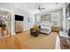 Bright bedroom with a sitting area, neutral walls, wood floors, and large windows with plantation shutters at 77 Streater Ln., Pawleys Island, SC 29585