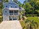 Charming coastal home with double garages, covered porch, palm trees and a beautifully landscaped front yard at 77 Streater Ln., Pawleys Island, SC 29585