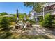 Backyard fire pit area featuring Adirondack chairs, a brick fire pit, and privacy landscaping at 77 Streater Ln., Pawleys Island, SC 29585