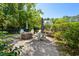 Charming backyard fire pit area with Adirondack chairs and manicured landscaping for outdoor enjoyment at 77 Streater Ln., Pawleys Island, SC 29585