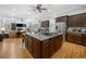 Spacious open kitchen featuring a central island with a cooktop and seating, adjacent to a cozy living area at 77 Streater Ln., Pawleys Island, SC 29585