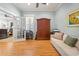 Cozy home office with a comfortable sofa, desk, shuttered window, and ample natural light at 77 Streater Ln., Pawleys Island, SC 29585