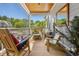 Cozy porch with various chairs, wooden ceiling, and an outdoor rug, perfect for relaxation at 77 Streater Ln., Pawleys Island, SC 29585