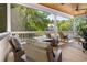 Relaxing screened porch featuring comfortable seating, a ceiling fan, and views of the landscaped yard at 77 Streater Ln., Pawleys Island, SC 29585