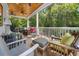 Spacious screened porch with a wood ceiling, ceiling fans, and comfortable seating arrangements at 77 Streater Ln., Pawleys Island, SC 29585