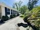 Backyard featuring well-maintained garden beds and lawn, complemented by lush greenery and mature trees at 801 Talbot Circle, Myrtle Beach, SC 29577