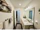 Bright bathroom featuring double sinks with marble countertops, modern lighting, and decorative accents at 801 Talbot Circle, Myrtle Beach, SC 29577