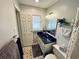 Bathroom featuring sleek black vanity, modern mirror, and decorative accents, enhanced by natural light from window at 801 Talbot Circle, Myrtle Beach, SC 29577