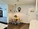 Cozy dining area with a wooden table and chairs, complemented by a vintage hanging lamp and décor at 801 Talbot Circle, Myrtle Beach, SC 29577