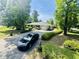 Exterior view featuring a well-manicured lawn, mature trees, and a paved driveway leading to the home at 801 Talbot Circle, Myrtle Beach, SC 29577