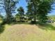 Well-maintained front yard features a neatly landscaped lawn and mature trees creating a welcoming curb appeal at 801 Talbot Circle, Myrtle Beach, SC 29577