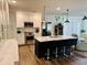 Beautiful kitchen features white cabinets, stainless appliances, island with bar seating, and pendant lighting at 801 Talbot Circle, Myrtle Beach, SC 29577