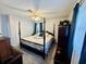 Spacious bedroom features a four-poster bed, neutral walls, and a ceiling fan, complemented by blue drapes at 801 Talbot Circle, Myrtle Beach, SC 29577