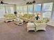 Bright sunroom filled with wicker furniture, floral cushions, and plenty of natural light at 801 Talbot Circle, Myrtle Beach, SC 29577