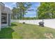 Spacious fenced backyard with lush grass, mature trees, and a privacy fence at 804 Twickenham Loop, Longs, SC 29568