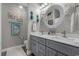 Bathroom with a dual sink vanity, a white quartz countertop, and a decorative mirror at 804 Twickenham Loop, Longs, SC 29568