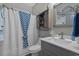 Cozy bathroom with a single sink vanity and shower with a blue patterned curtain at 804 Twickenham Loop, Longs, SC 29568