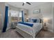 This bedroom features a ceiling fan, large window and beach themed decor at 804 Twickenham Loop, Longs, SC 29568