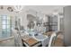 Open dining area with seating for eight, modern light fixture, and backyard access at 804 Twickenham Loop, Longs, SC 29568