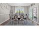 Bright dining room with a large window, stylish decor, and seating for six at 804 Twickenham Loop, Longs, SC 29568