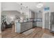 Open-concept kitchen featuring gray cabinets, granite counters, stainless appliances, and wood floors at 804 Twickenham Loop, Longs, SC 29568