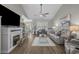 Bright and airy living room featuring hardwood floors, fireplace, and open access to the kitchen at 804 Twickenham Loop, Longs, SC 29568