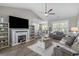 Open concept living room featuring hardwood floors, a fireplace, and access to the kitchen at 804 Twickenham Loop, Longs, SC 29568