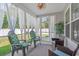 Relaxing sunroom with comfortable seating, bright natural light, and backyard views at 804 Twickenham Loop, Longs, SC 29568