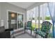 Bright sunroom with comfortable seating, neutral colors, and sliding door access to backyard at 804 Twickenham Loop, Longs, SC 29568