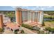 Aerial view of impressive building with attractive landscaping and brick paved driveway at 8121 Amalfi Pl. # 4-801, Myrtle Beach, SC 29572