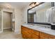 Bathroom featuring double sinks with granite countertops and decorative mirror at 8121 Amalfi Pl. # 4-801, Myrtle Beach, SC 29572