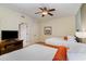 Bedroom showcasing comfortable beds, ceiling fan, TV, and bathroom access at 8121 Amalfi Pl. # 4-801, Myrtle Beach, SC 29572