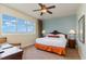 Bedroom showcasing comfortable bed, ceiling fan, window view, and writing desk at 8121 Amalfi Pl. # 4-801, Myrtle Beach, SC 29572