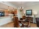 Dining area overlooking a kitchen with wooden cabinets, granite countertops, and modern appliances at 8121 Amalfi Pl. # 4-801, Myrtle Beach, SC 29572