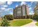 Lush lawn landscaping surrounds this impressive building with private balconies overlooking beautifully maintained green spaces at 8121 Amalfi Pl. # 4-801, Myrtle Beach, SC 29572