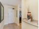 Hallway showing a white entry door, small granite countertop, and an ornate decorative vase at 8121 Amalfi Pl. # 4-801, Myrtle Beach, SC 29572