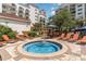 Take a dip in this attractive hot tub surrounded by lounge chairs, tables, and lush, beautiful landscaping in this outdoor area at 8121 Amalfi Pl. # 4-801, Myrtle Beach, SC 29572
