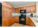 Kitchen with light wood cabinets, granite countertops, and black appliances at 8121 Amalfi Pl. # 4-801, Myrtle Beach, SC 29572