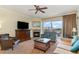 Cozy living room featuring a fireplace, ceiling fan, comfortable seating, and balcony access with a view at 8121 Amalfi Pl. # 4-801, Myrtle Beach, SC 29572