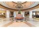 The grand lobby has gorgeous flooring, seating surrounding floral display, elegant chandelier, and access to the interior amenities at 8121 Amalfi Pl. # 4-801, Myrtle Beach, SC 29572