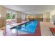 The indoor pool area boasts ample natural light, lounge seating, and easy access with entry stairs and a chair lift at 8121 Amalfi Pl. # 4-801, Myrtle Beach, SC 29572