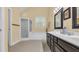 Bright main bathroom featuring double sinks, dark wood cabinets, a soaking tub, and a separate glass enclosed shower at 813 Bear Lake Dr., Longs, SC 29568