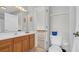 Bright bathroom with a wooden cabinet and an open door to the hallway at 813 Bear Lake Dr., Longs, SC 29568